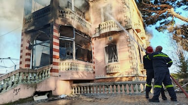 Lebanese Civil Defence try to put out a fire in a building after it was hit by an Israeli air strike. Reuters.