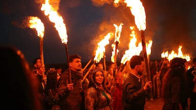 Syrian Kurds carry flaming torches to celebrate the spring festival Nowruz, in the village of Tel Mozan, north-eastern Syria. AFP