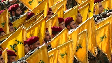 Hezbollah fighters raise their group's flags and shout slogans as they attend the mass funeral of Hezbollah's chief of staff Haytham Tabtabai (Sayyed Abu Ali) in the southern suburbs of Beirut, Lebanon, in November. EPA