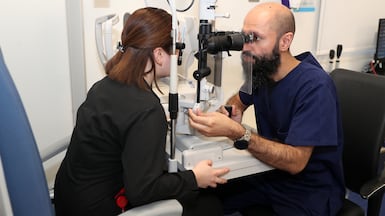 An optometrist examines a patient at the Moorfields eye hospital in Abu Dhabi. Cash-rich investment funds in the GCC are looking to life sciences, pharmaceutical and healthcare assets in the UK, the US and Europe. Pawan Singh / The National