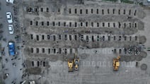 Graves are prepared for the victims of an air strike on a girls' school in Minab, southern Iran. EPA