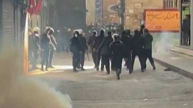 Iranian security forces use tear gas to disperse demonstrators in a Tehran bazaar on Tuesday. AFP